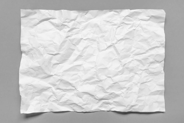 Modern crumpled white paper on empty sheet gray background with light shadows for creative wallpaper, card, art work design - Foto, Bild