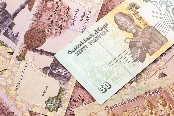Egy közeli kép egy egyiptomi ötven piaszteres bankjegyről egyiptomi egyfontos bankjegyekkel makróban. - Fotó, kép