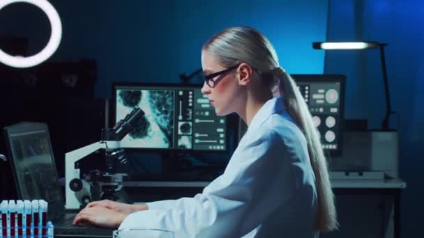 Scientist working in lab. Female doctor making medical research. Laboratory tools: microscope, test tubes, equipment. Coronavirus 2019-ncov, biotechnology, science, experiments and healthcare concept. - Footage, Video