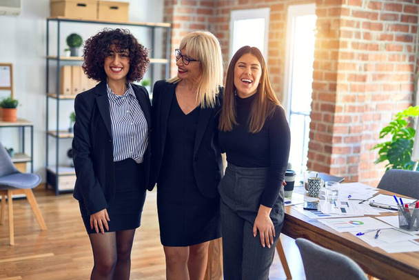 Group of beautiful businesswomen smiling happy and confident. Posing together with smile on face looking at the camera at the office - Fotografie, Obrázek