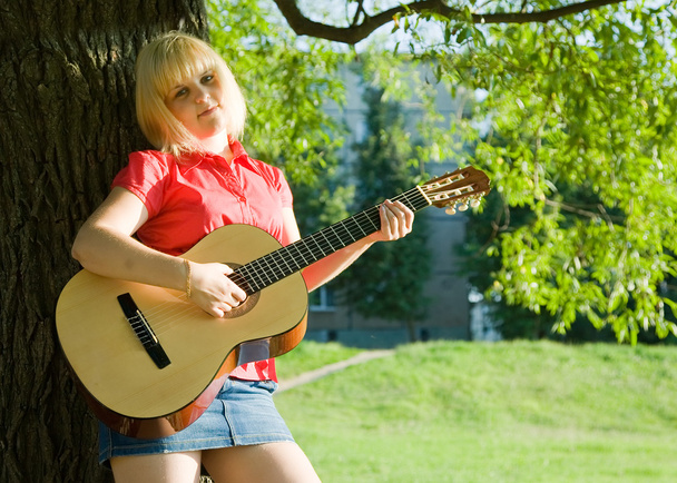 Teenager girl with guitar - Фото, изображение
