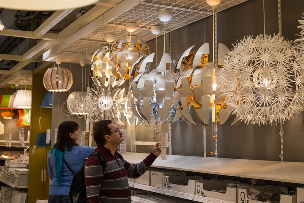 Moscow, Russia - February 10, 2018: Beautiful Different Modern Stylish Lamps And Lighting. Male Buyer Choose Liked Lamps   In Store IKEA. - Foto, Imagen