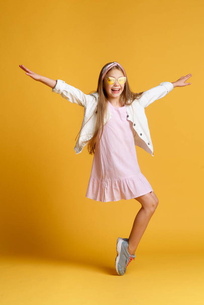 Jump of happiness. small girl jump yellow background. full of energy. Active girl feel freedom. Fun and relax. feeling free. carefree kid on summer holiday. time for fun. retro beauty in mid air. - Foto, afbeelding