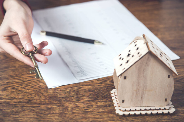 woman hand  house model with documents on desk - 写真・画像