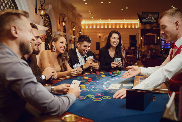 People gamble at a poker table in a casino - Valokuva, kuva