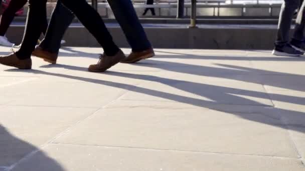 Low angle of people walking on street in London - Filmati, video