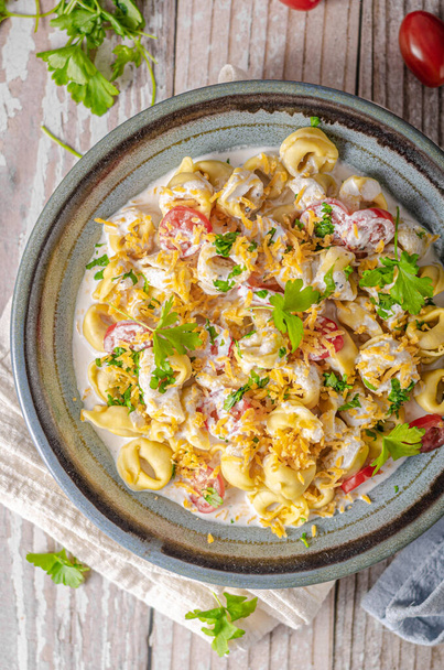 Italian tortellini with herbs and cheese sauce - Photo, image