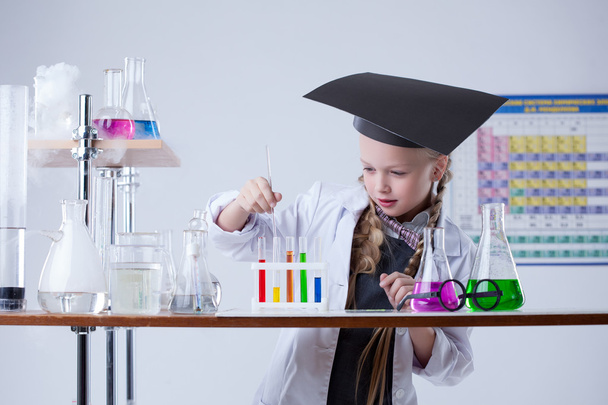 Image of smart little girl mixes reagents in lab - Photo, image