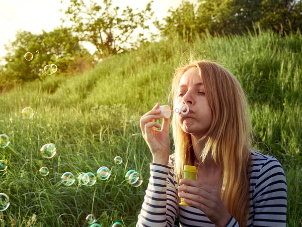 Girl blowing a bubbles. - Фото, зображення