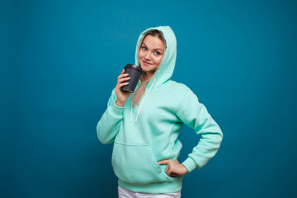Stylish trendy hipster girl in a blue hoodie with a hood - Фото, изображение