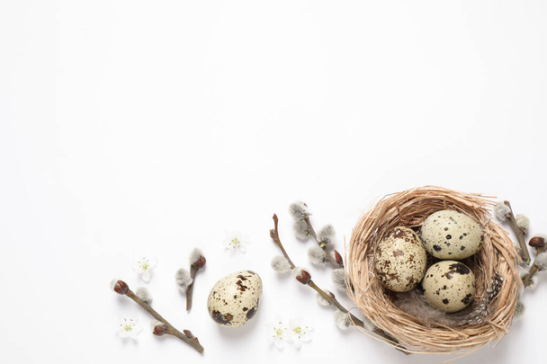 Flat lay composition with quail eggs on white background, space for text. Easter celebration - Foto, Imagen