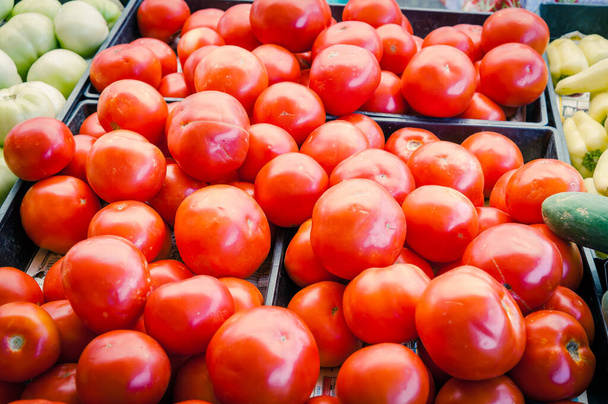 Pile of red, green tomatoes and jalapeno in plastic wood crate at farmer market in Washington, USA - Photo, Image