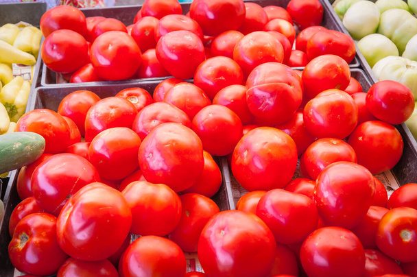 Pile of red, green tomatoes and jalapeno in plastic wood crate at farmer market in Washington, USA - Photo, Image