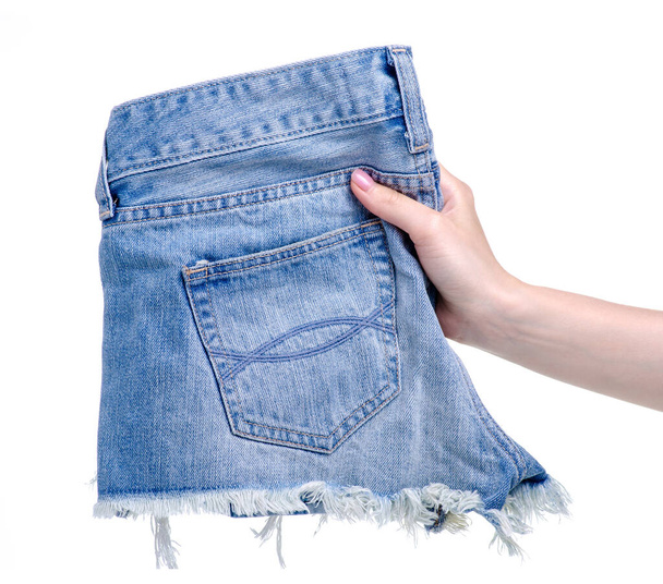 Denim shorts in the hands - Фото, изображение