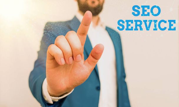 Writing note showing Seo Service. Business photo showcasing techniques and procedures to increase the website visibility Businessman with pointing finger in front of him. - Фото, изображение