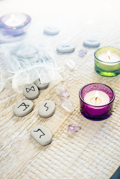 Stone runes on the light wooden background. Magical items concept. - Photo, Image