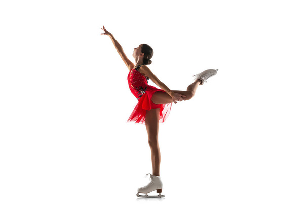 Girl figure skating isolated on white studio backgound with copyspace - Foto, Imagen