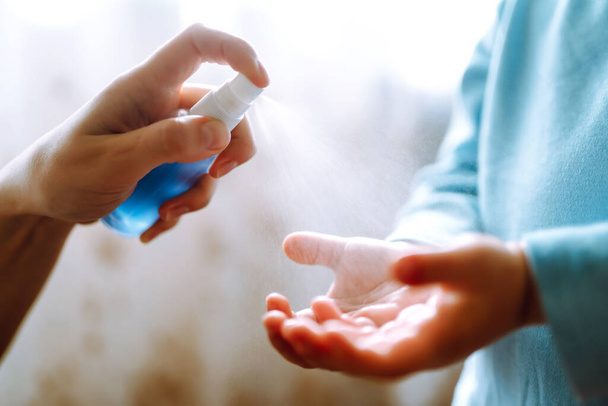 Hands with sanitizer antiseptic. Mother and child using sanitize antiseptic for hand coronavirus protection.Hygiene concept. Prevent spread of germs and bacteria and avoid infections coronavirus. - Foto, imagen