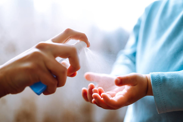 Hands with sanitizer antiseptic. Mother and child using sanitize antiseptic for hand coronavirus protection.Hygiene concept. Prevent spread of germs and bacteria and avoid infections coronavirus. - Zdjęcie, obraz