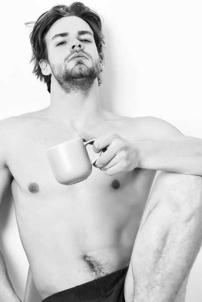 Caucasian bearded sexy macho holding coffee cup - Foto, afbeelding