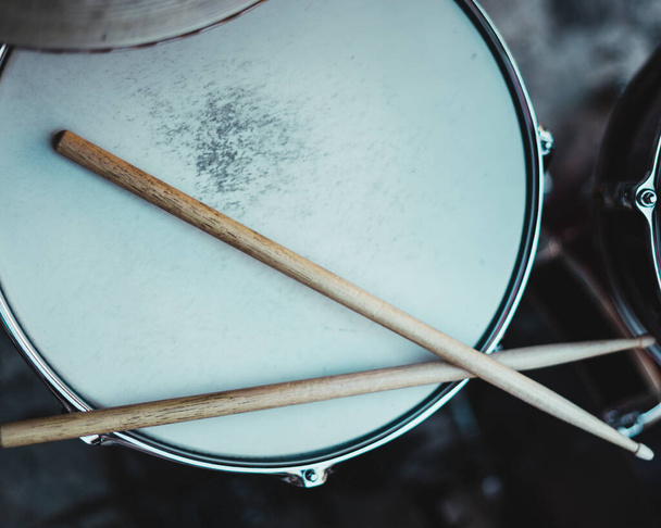 Pretty drummer with drumsticks in an underground environment - Фото, зображення
