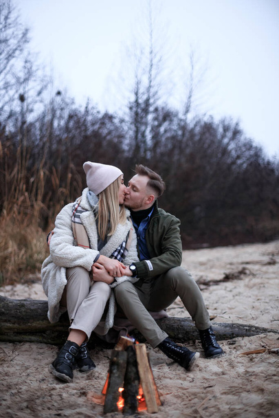 Winter picnic on baech with bonfire. Love story on winter foggy sand beach. valentines concept. - Photo, Image