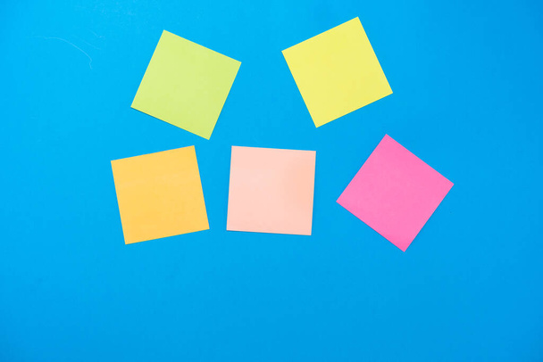 colored stickers for notes on a blue background - Photo, Image