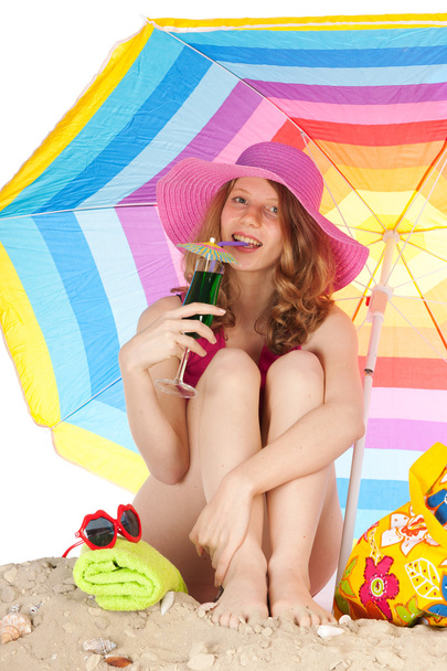 Sunbathing at the beach with colorful parasol - Foto, immagini