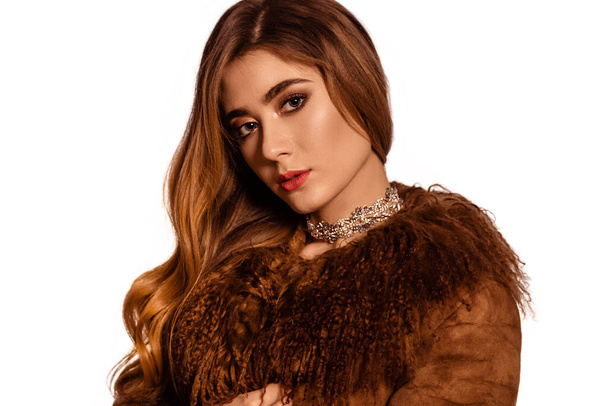 Beautiful, fashionable girl in a brown fur coat from llama fur. Luxury Winter Women. White, isolated background. Close Up portrait. - Foto, Imagem