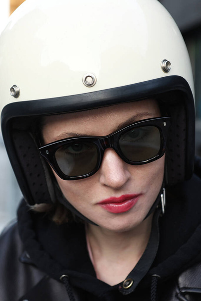 Close-up portrait of biker girl wearing white helmet.  - Zdjęcie, obraz
