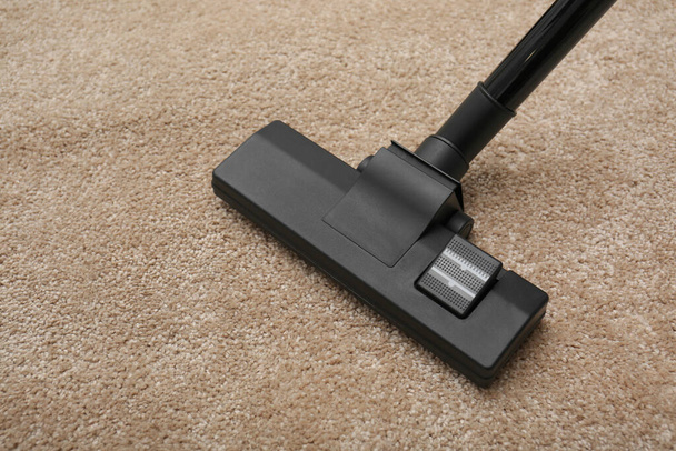 Removing dirt from carpet with modern vacuum cleaner indoors - Foto, Bild