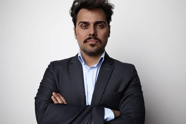Young business man wearing suit posing at the white background. Horizontal. - Φωτογραφία, εικόνα
