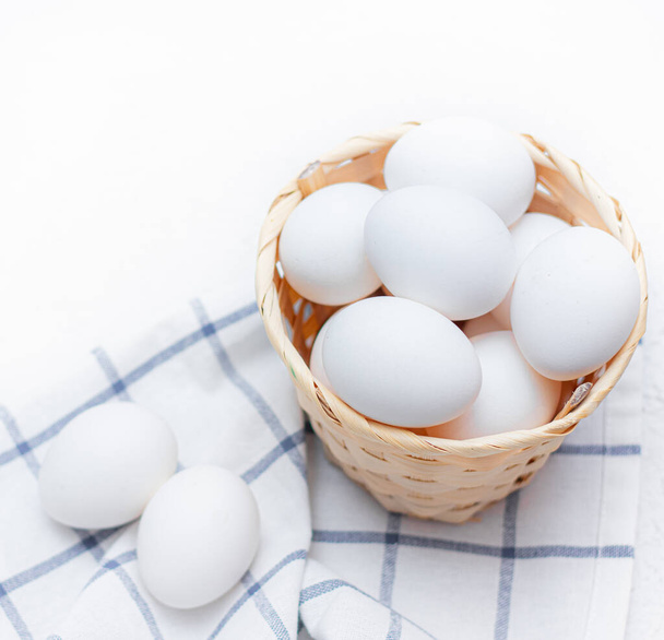 chicken eggs on a checked kitchen towel on a light table. concept of farm products and natural food. Article about home products. Fresh chicken eggs . Healthy diet - Φωτογραφία, εικόνα