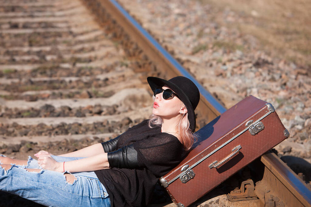 Young traveling woman with a suitcase on the railway - Photo, Image