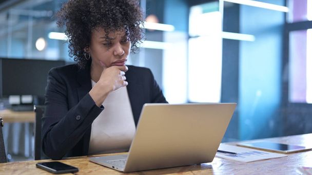 Jeune femme d'affaires professionnelle Réfléchir et travailler sur ordinateur portable au bureau
 - Photo, image