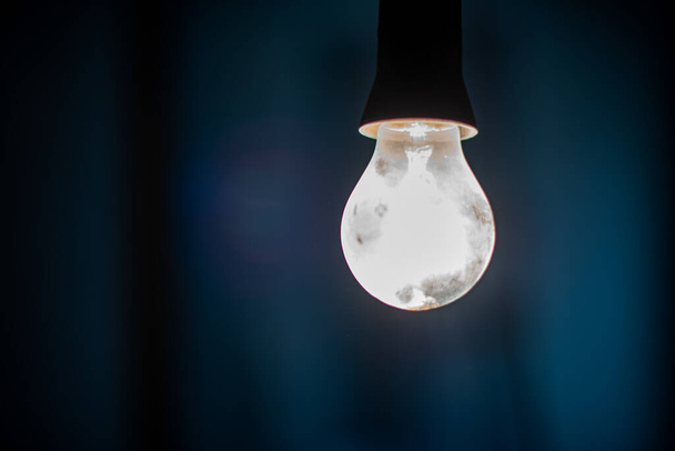 Electric lighting bulb on the dark background - Photo, Image
