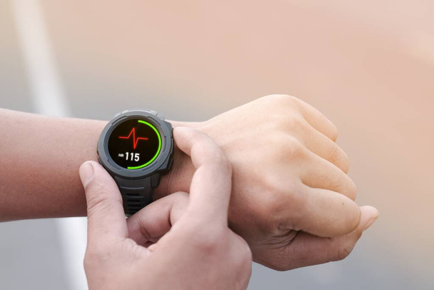 A man using smart watch for tracking running - Photo, Image