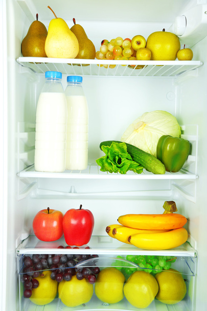 Milk, vegetables and fruits in refrigerator - Foto, Bild