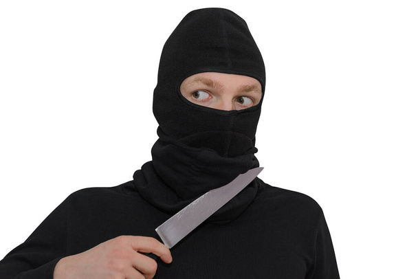 man in a balaclava with a knife portrait isolated on a white background  - Фото, изображение