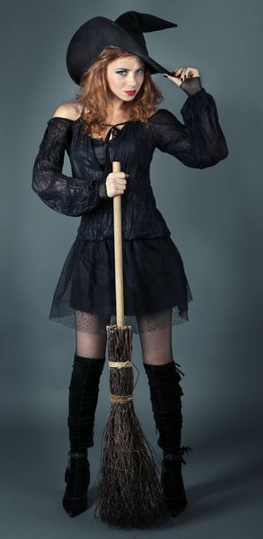 Halloween witch with broom on gray background - Fotografie, Obrázek