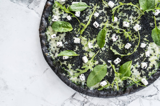 pizza with black caviar, top view - 写真・画像