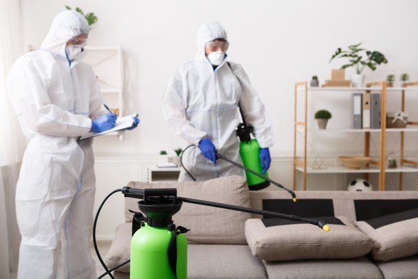 Men in hazmat suits cleaning home, epidemic - Zdjęcie, obraz