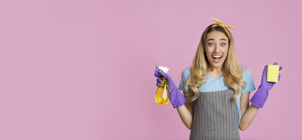 Positive girl with hair curlers holds sponge and spray - Zdjęcie, obraz