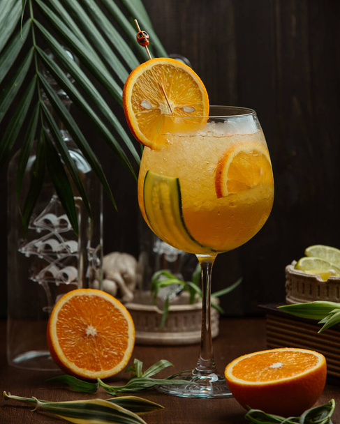 orange cocktail with cucumber  and orange slices - Fotografie, Obrázek