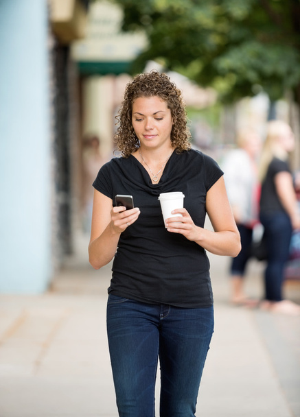 Woman With Coffee Cup Using Smartphone On Pavement - Zdjęcie, obraz