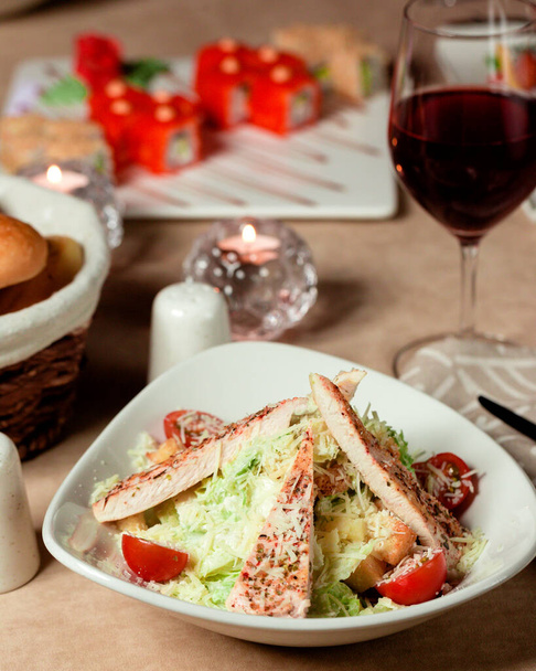 caesar salad with chicken lettuce parmesan cherry tomato and bread stuffing - Valokuva, kuva