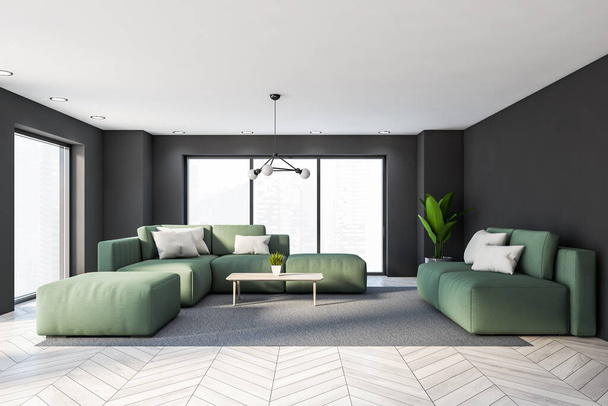 Interior of panoramic living room with grey walls, wooden floor, two comfortable green sofas near coffee table and window with blurry cityscape. 3d rendering - 写真・画像
