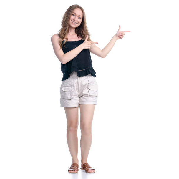 Woman in shorts showing pointing - Foto, Imagen