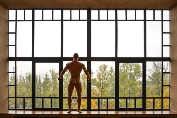 umięśniony mężczyzna model w oknie - Zdjęcie, obraz