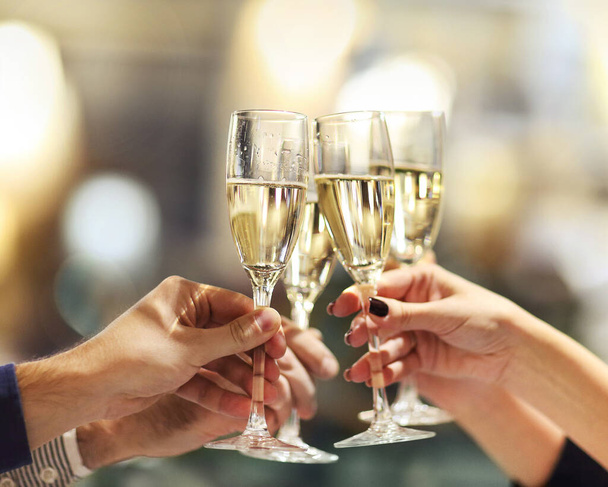 Celebration. People holding glasses of champagne making a toast. Champage with blurred background - Фото, изображение